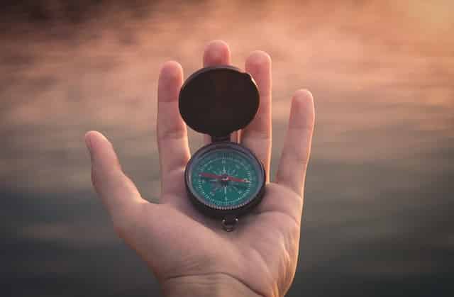person holding a compass