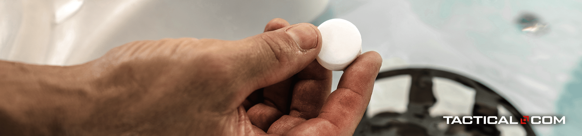 hand holding a water purification tablet
