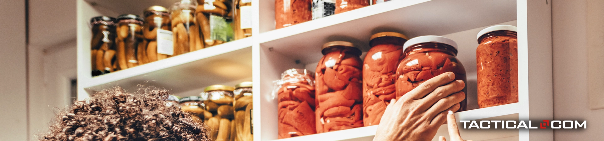 person reaching for a jar of food on the shelf