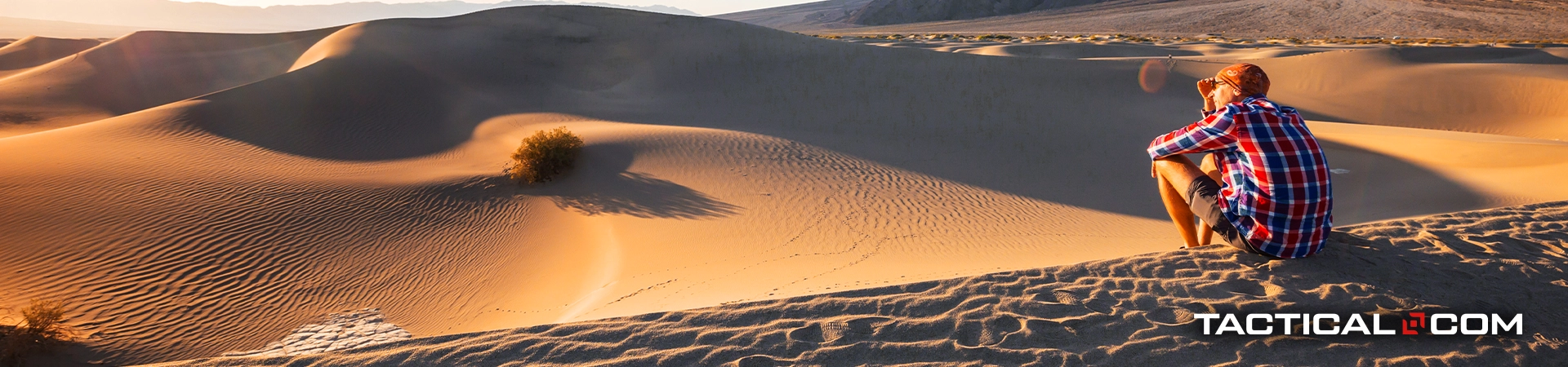 man in a desert looking at his surroundings