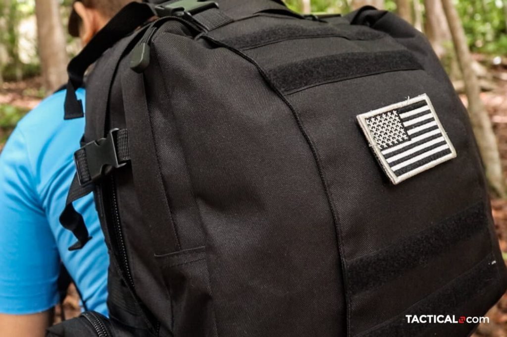 black tactical backpack strapped to a man's back