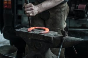blacksmith forging a horseshoe