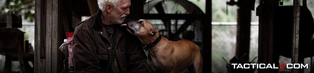 an old man and his dog staring at each other