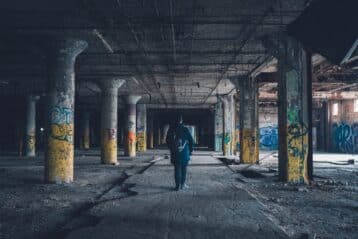 man walking through urban survival jungle