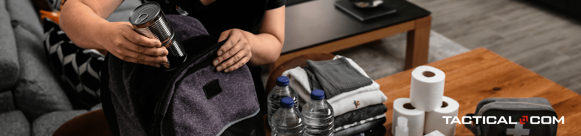 person putting emergency supplies inside bag