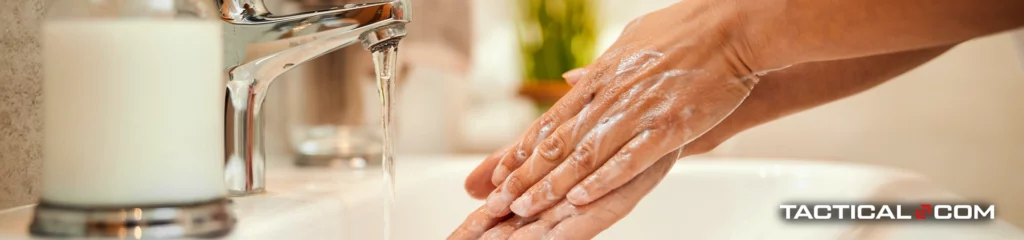 person washing their hands with soap